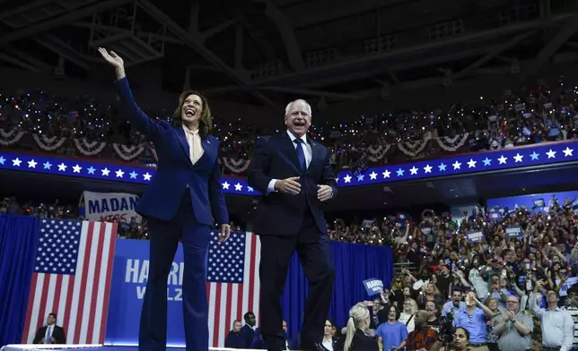 Democratic presidential nominee Vice President Kamala Harris and her running mate Minnesota Gov. Tim Walz arrive at a campaign rally in Philadelphia, Tuesday, Aug. 6, 2024. (AP Photo/Matt Rourke)