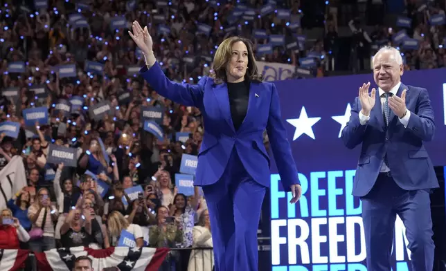 Democratic presidential nominee Vice President Kamala Harris arrives with running mate Minnesota Gov. Tim Walz at the Fiserv Forum during a campaign rally in Milwaukee, Tuesday, Aug. 20, 2024. (AP Photo/Jacquelyn Martin)