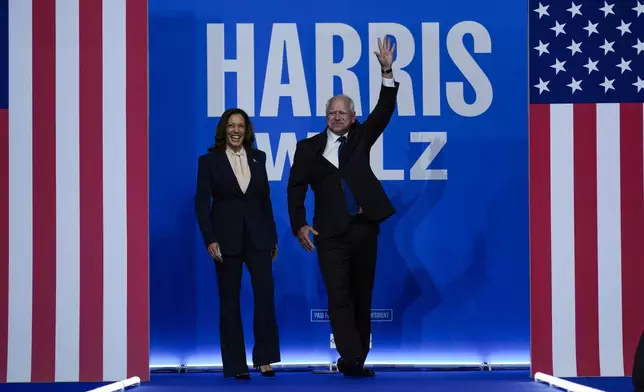 Democratic presidential nominee Vice President Kamala Harris and her running mate Minnesota Gov. Tim Walz arrive at a campaign rally in Philadelphia, Tuesday, Aug. 6, 2024. (AP Photo/Matt Rourke)