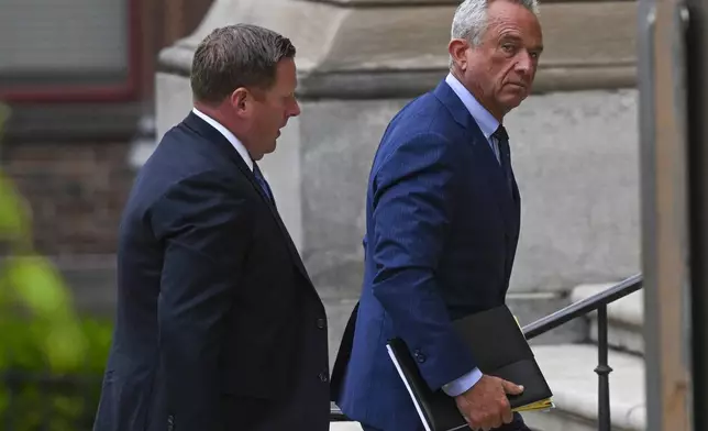 Independent presidential candidate Robert F. Kennedy Jr., right, arrives at the Albany County Courthouse to fight a lawsuit he falsely claimed to live in New York state, Tuesday, Aug. 6, 2024, in Albany, N.Y. (AP Photo/Hans Pennink)