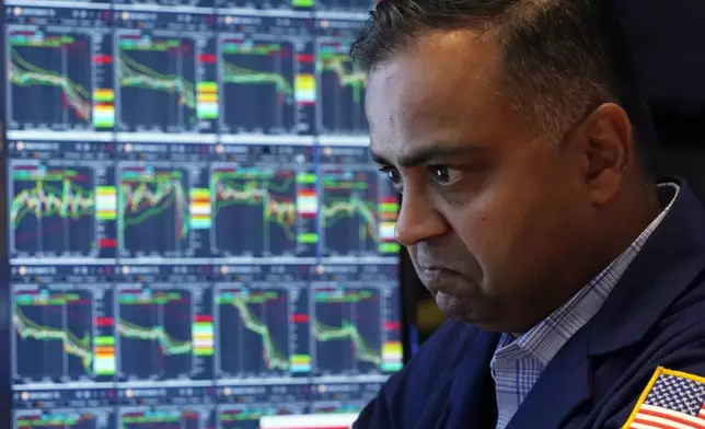 Specialist Dilip Patel works at his post on the floor of the New York Stock Exchange, Monday, Aug. 5, 2024. Nearly everything on Wall Street is tumbling as fear about a slowing U.S. economy worsens and sets off another sell-off for financial markets around the world.(AP Photo/Richard Drew)