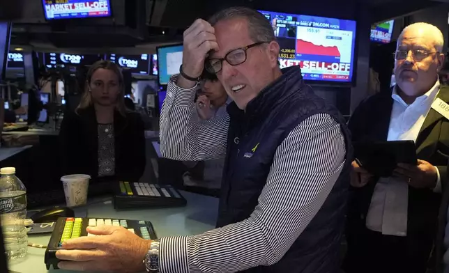 Specialist Glenn Carell works at his post on the floor of the New York Stock Exchange, Monday, Aug. 5, 2024. Nearly everything on Wall Street is tumbling as fear about a slowing U.S. economy worsens and sets off another sell-off for financial markets around the world. (AP Photo/Richard Drew)