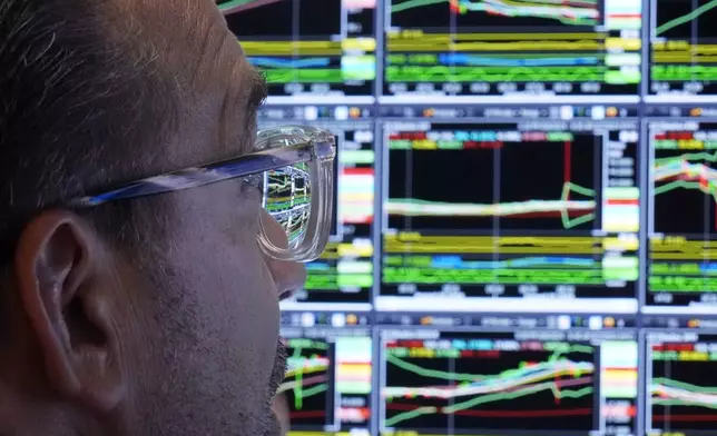 The monitor of specialist Anthony Matesic is seen through his glasses as he works on the floor of the New York Stock Exchange, Wednesday, Aug. 7, 2024. (AP Photo/Richard Drew)