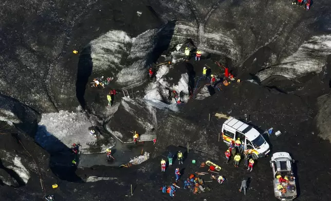 Rescue teams work at the scene after an ice cave partially collapsed, at the Breidamerkurjokull glacier, in southeastern Iceland, Monday, Aug, 26, 2024. (STOD2/ Vilhelm Gunnarsson via AP)