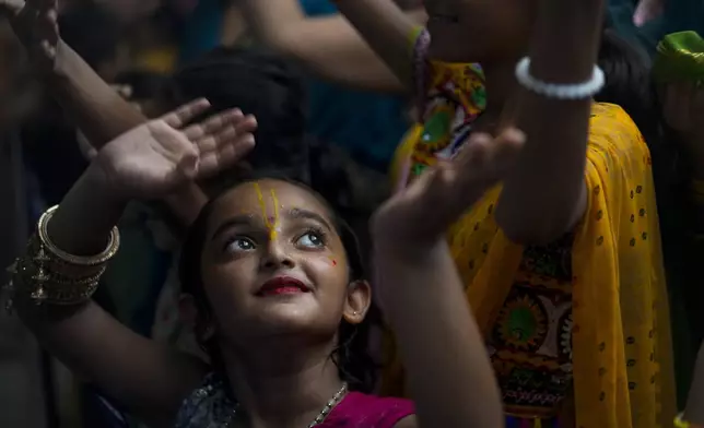 A Hindu girl dances during Janmashtami festival that marks the birthday of Lord Krishna at a temple in Jammu, India, Monday, Aug. 26, 2024. (AP Photo/Channi Ananad)