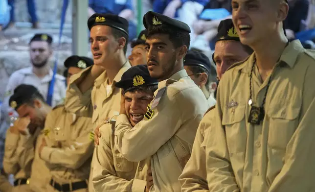 Israeli Navy sailors mourn during the funeral of Petty Officer 1st Class David Moshe Ben Shitrit, who was killed on a Hezbollah attack, at the Mount Herzl military cemetery in Jerusalem, Sunday, Aug. 25, 2024. (AP Photo/Ohad Zwigenberg)