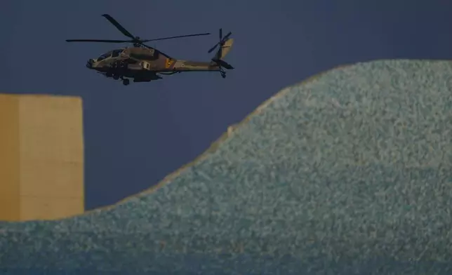 An Israeli Apache helicopter flies over Israel, Sunday, Aug. 25, 2024. (AP Photo/Ariel Schalit)