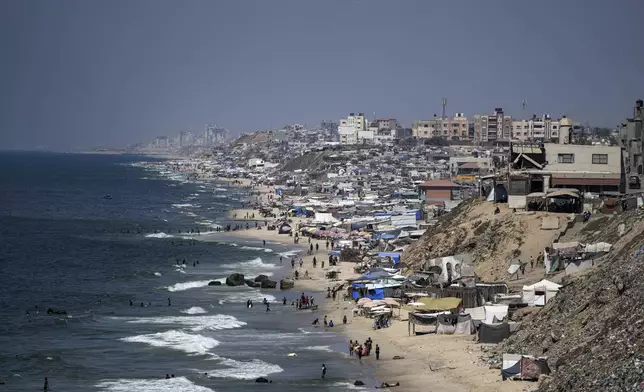 Tents are crammed together as displaced Palestinians camp on the beach, west of Deir al-Balah, Gaza Strip, Tuesday, Aug. 20, 2024. (AP Photo/Abdel Kareem Hana)