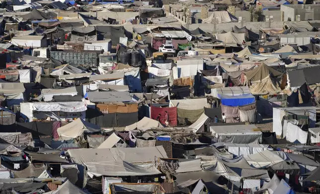 Tents are crammed together as displaced Palestinians camp on the beach, west of Deir al-Balah, Gaza Strip, Tuesday, Aug. 20, 2024. (AP Photo/Abdel Kareem Hana)