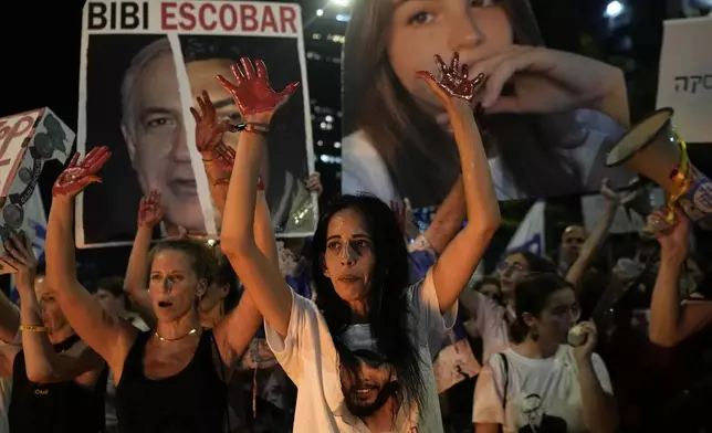 Einav Zangauker, center, the mother of hostage Matan Zangauker, who was kidnapped by Hamas, protests for his immediate release along with other families of hostages held in the Gaza Strip and their supporters and against Israeli Prime Minister Benjamin Netanyahu's government in Tel Aviv, Israel, Saturday, Aug. 17, 2024. (AP Photo/Tsafrir Abayov)