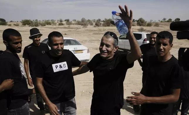 Qaid Farhan Alkadi, 52, who was held hostage by Hamas militants in Gaza Strip, meets his relatives and friends after arriving in the Khirbet Karkur village, near Rahat, southern Israel, Wednesday, Aug. 28, 2024. (AP Photo/Mahmoud Illean)