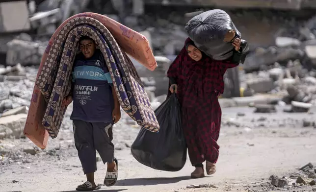 Palestinians displaced by the Israeli air and ground offensive on the Gaza Strip flee from Hamad City, following an evacuation order by the Israeli army to leave parts of the southern area of Khan Younis, Sunday, Aug. 11, 2024. (AP Photo/Abdel Kareem Hana)