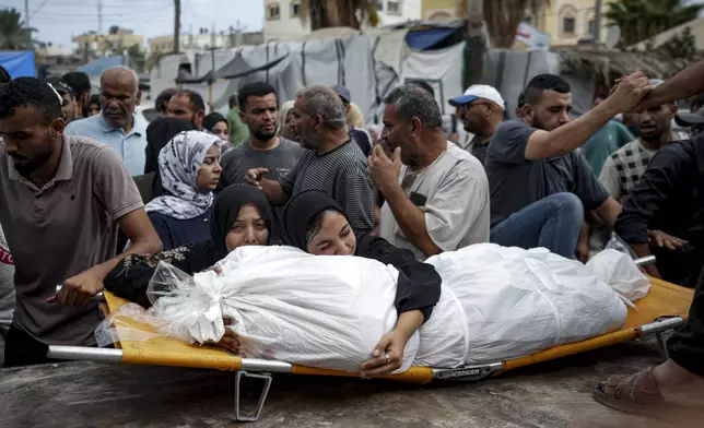 Palestinian women mourn a relative killed in the Israeli bombardment of the Gaza Strip, at a hospital in Deir al-Balah, Thursday, Aug. 22, 2024. (AP Photo/Abdel Kareem Hana)