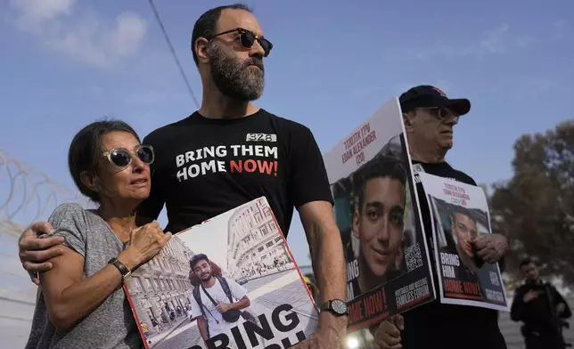 Rachel Goldberg, left, and Jon Polin center, parents of Israeli-American hostage Hersh Polin-Goldberg, along with other relatives of hostages held in the Gaza Strip by the Hamas militant group take part in a protest calling for their release in the Kibbutz Nirim, southern Israel, Thursday, Aug. 29, 2024. (AP Photo/Tsafrir Abayov)