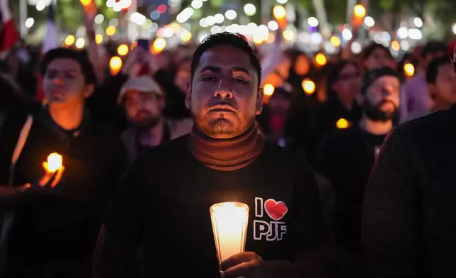 A unionized federal court worker protests against over reforms that would make all judges stand for election in Mexico City, Monday, Aug. 26, 2024. (AP Photo/Eduardo Verdugo)