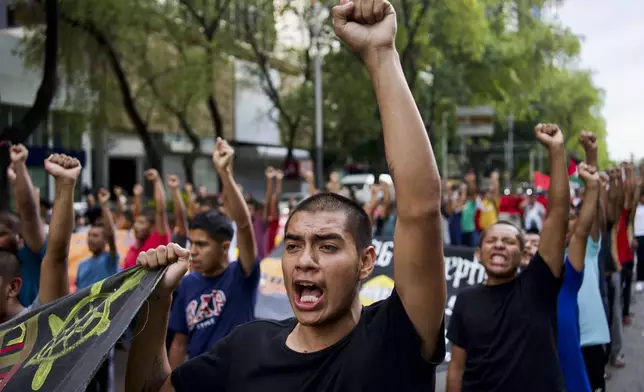 Classmates of the 43 Ayotzinapa students who went missing almost 10 years ago march to demand justice for their loved ones in Mexico City, Monday, Aug. 26, 2024. (AP Photo/Felix Marquez)