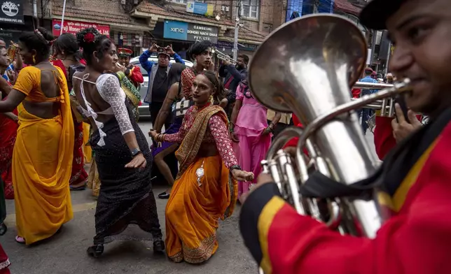 LGBTQ+ people and their supporters dance and rally during the annual pride parade, in Kathmandu, Nepal, Tuesday, Aug. 20, 2024. (AP Photo/Niranjan Shrestha)