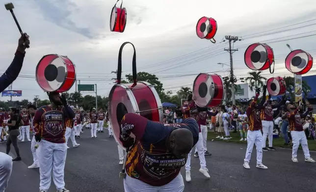 Musicians parade to celebrate the anniversary of the founding of the Jua Diaz neighborhood in Panama City, Sunday, Aug. 25, 2024. (AP Photo/Matias Delacroix)