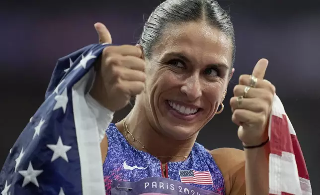 Valarie Allman, of the United States, gestures after winning the gold medal in the women's discus throw final at the 2024 Summer Olympics, Monday, Aug. 5, 2024, in Saint-Denis, France. (AP Photo/Ashley Landis)