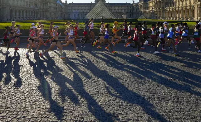 Athletes compete during the women's marathon competition at the 2024 Summer Olympics, Sunday, Aug. 11, 2024, in Paris, France. (AP Photo/Vadim Ghirda)