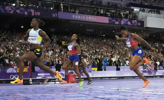 Julien Alfred, of Saint Lucia, from left, Sha'carri Richardson, of the United States, and Melissa Jefferson, of the United States, run in the women's 100-meter final at the 2024 Summer Olympics, Saturday, Aug. 3, 2024, in Saint-Denis, France. (AP Photo/David J. Phillip)