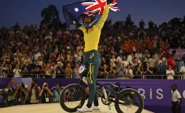 Saya Sakakibara of Australia celebrates clinching the gold medal in a BMX racing event, at the 2024 Summer Olympics, Friday, Aug. 2, 2024, in Saint-Quentin-en-Yvelines, France. (AP Photo/Thibault Camus)