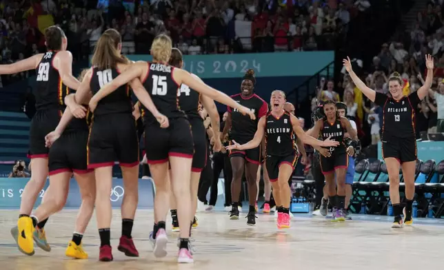 Elisa Ramette (4), of Belgium, and the rest of the Belgian tam celebrate after a women's quarterfinal game against Spain at Bercy Arena at the 2024 Summer Olympics, Wednesday, Aug. 7, 2024, in Paris, France. (AP Photo/Mark J. Terrill)