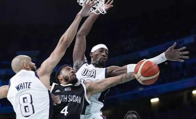 Carlik Jones, of South Sudan, shoots between Derrick White, (8) and Jayson Tatum, of the United States, in a men's basketball game at the 2024 Summer Olympics, Wednesday, July 31, 2024, in Villeneuve-d'Ascq, France. (AP Photo/Mark J. Terrill)