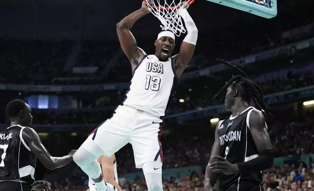 Bam Adebayo, of the United States, reacts after a dunk over Wenyen Gabriel, of South Sudan, in a men's basketball game at the 2024 Summer Olympics, Wednesday, July 31, 2024, in Villeneuve-d'Ascq, France. (AP Photo/Mark J. Terrill)