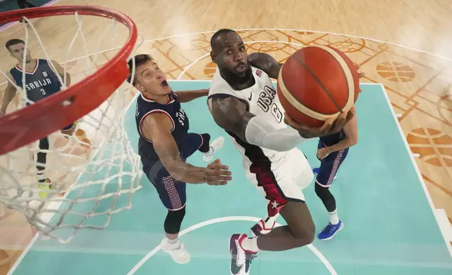 United States' LeBron James (6) shoots during a men's semifinal basketball game against Serbia at Bercy Arena at the 2024 Summer Olympics, Thursday, Aug. 8, 2024, in Paris, France. (AP Photo/Mark J. Terrill,Pool)