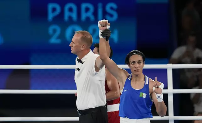 Algeria's Imane Khelif gestures after defeating Thailand's Janjaem Suwannapheng in their women's 66 kg semifinal boxing match at the 2024 Summer Olympics, Tuesday, Aug. 6, 2024, in Paris, France. (AP Photo/Ariana Cubillos)