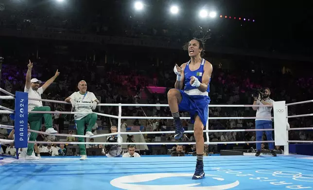 Algeria's Imane Khelif celebrates after defeating Thailand's Janjaem Suwannapheng in their women's 66 kg semifinal boxing match at the 2024 Summer Olympics, Tuesday, Aug. 6, 2024, in Paris, France. (AP Photo/John Locher)