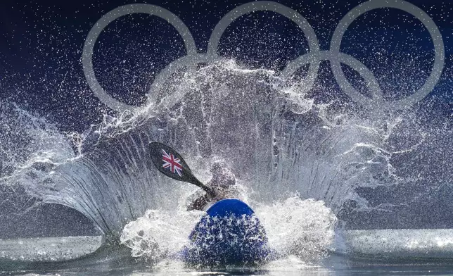 Kimberley Woods of Britain competes in the women's kayak cross time trial at the 2024 Summer Olympics, Friday, Aug. 2, 2024, in Vaires-sur-Marne, France. (AP Photo/Kirsty Wigglesworth)