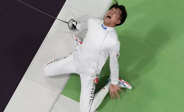 Japan's Masaru Yamada celebrates after winning the men's team epee semifinal match against the Czech Republic at the 2024 Summer Olympics, Friday, Aug. 2, 2024, in Paris, France. (AP Photo/Christophe Ena)