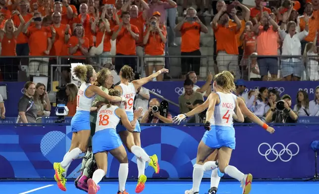 Netherlands' players celebrate after winning the women's gold medal field hockey match against China at the Yves-du-Manoir Stadium during the 2024 Summer Olympics, Friday, Aug. 9, 2024, in Colombes, France. (AP Photo/ Anjum Naveed)