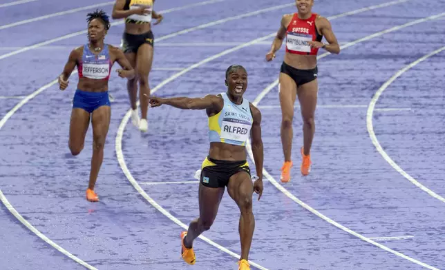 Julien Alfred, of Saint Lucia, celebrates after winning the women's 100-meter final at the 2024 Summer Olympics, Saturday, Aug. 3, 2024, in Saint-Denis, France. (AP Photo/David Goldman)