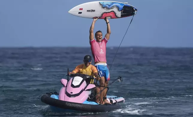 Kauli Vaast, of France, celebrates after winning the gold medal match of the surfing competition at the 2024 Summer Olympics, Monday, Aug. 5, 2024, in Teahupo'o, Tahiti. (AP Photo/Gregory Bull)