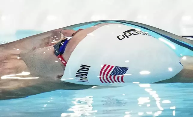 Ryan Murphy, of the United States, competes during a heat in the men's 100-meter backstroke at the 2024 Summer Olympics, Sunday, July 28, 2024, in Nanterre, France. (AP Photo/Bernat Armangue)