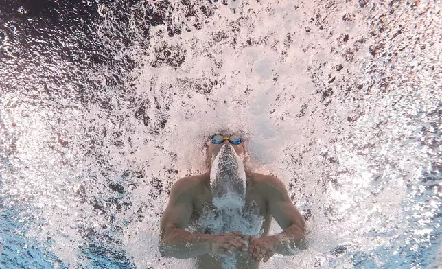 Tomoru Honda, of Japan, competes during a heat in the men's 200-meter butterfly at the 2024 Summer Olympics, Tuesday, July 30, 2024, in Nanterre, France. (AP Photo/David J. Phillip)