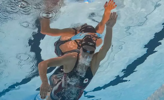 Summer McIntosh, of Canada, competes during a heat in the women's 400-meter freestyle at the 2024 Summer Olympics, Saturday, July 27, 2024, in Nanterre, France. (AP Photo/David J. Phillip)