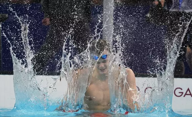 Hubert Kos, of Hungary, celebrates after winning the men's 200-meter backstroke final at the 2024 Summer Olympics, Thursday, Aug. 1, 2024, in Nanterre, France. (AP Photo/Matthias Schrader)