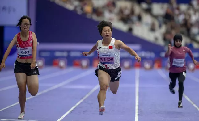 Paralympic athlete Zia Zhou, of China, wins the Women's 100m -T35 final, at the Stade de France stadium, during the 2024 Paralympics, Friday, Aug. 30, 2024, in Paris, France. (AP Photo/Emilio Morenatti)