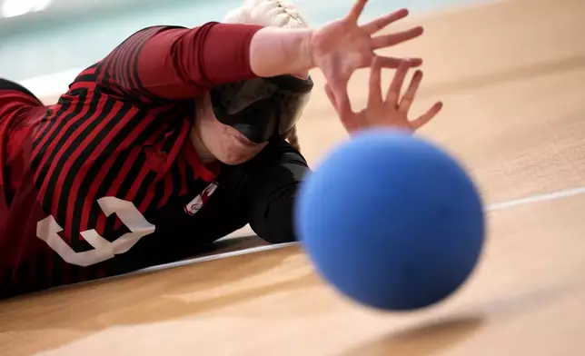 Whitney Bogart dives to catch the ball during during the Women's preliminary round Goalball game against France at the 2024 Paralympics, Thursday, Aug. 29, 2024, in Paris, France. (AP Photo/Christophe Ena)