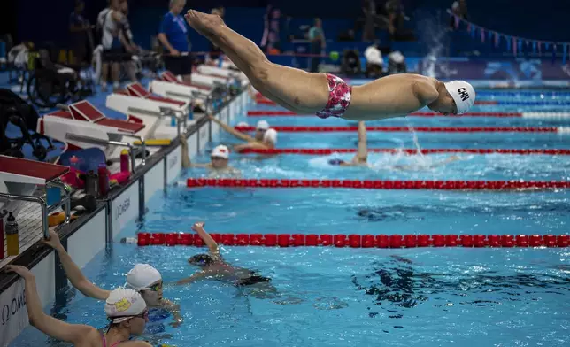 Yuan Weiyi, from China, jumps into the pool during a training session ahead of the 2024 Paralympics, Tuesday, Aug. 27, 2024, in Paris, France. (AP Photo/Emilio Morenatti)