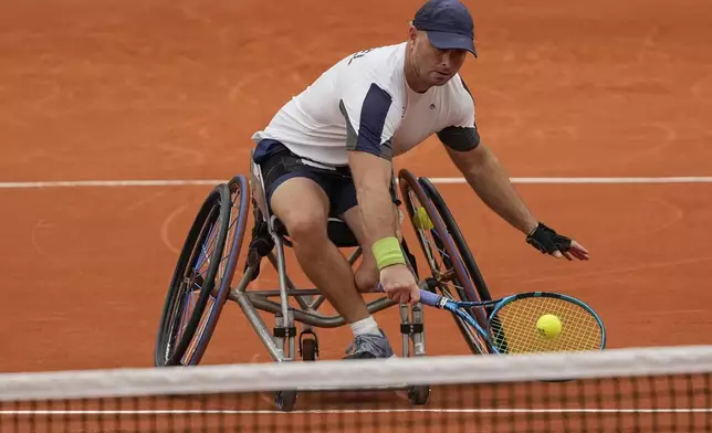 Israel's Adam Berdichevsky returns the ball to Italy's Luca Arca during their 2024 Paralympics men's Wheelchair singles tennis tournament first round match at Roland Garros Stadium in Paris, France, Friday Aug. 30, 2024. (AP Photo/Michel Euler)