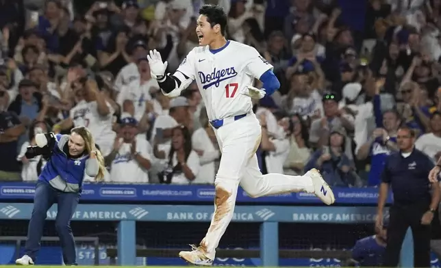 Los Angeles Dodgers designated hitter Shohei Ohtani (17) runs the bases after hitting a grand slam during the ninth inning of a baseball game against the Tampa Bay Rays in Los Angeles, Friday, Aug. 23, 2024. The Dodgers won 7-3. Will Smith, Tommy Edman, and Max Muncy also scored. (AP Photo/Ashley Landis)