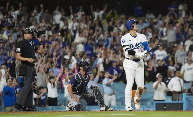 Los Angeles Dodgers designated hitter Shohei Ohtani (17) hits a grand slam during the ninth inning of a baseball game against the Tampa Bay Rays in Los Angeles, Friday, Aug. 23, 2024. The Dodgers won 7-3. Will Smith, Tommy Edman, and Max Muncy also scored. (AP Photo/Ashley Landis)