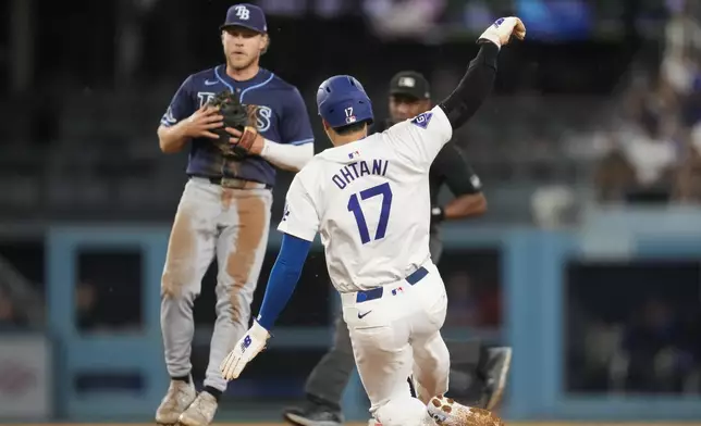 Los Angeles Dodgers designated hitter Shohei Ohtani (17) steals second base during the fifth inning of a baseball game against the Tampa Bay Rays in Los Angeles, Friday, Aug. 23, 2024. (AP Photo/Ashley Landis)