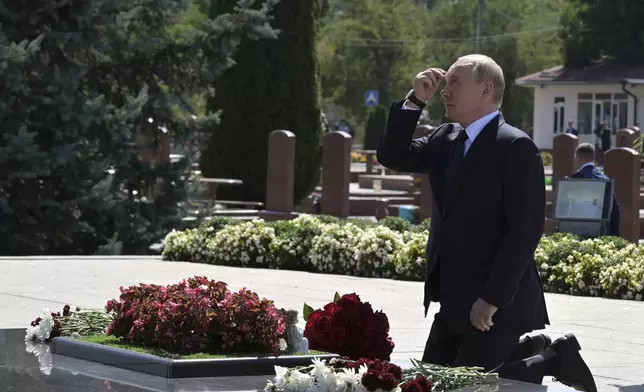 Russian President Vladimir Putin attends a ceremony to lay flowers at the City of Angels cemetery, where the victims of the 2004 Beslan school siege were buried, in Beslan, Republic of North Ossetia-Alania, Russia, Tuesday, Aug. 20, 2024. (Vladimir Astapkovich, Sputnik, Kremlin Pool Photo via AP)