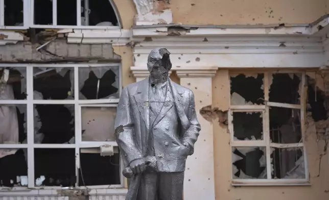 A damaged monument to Soviet founder Vladimir Lenin stands in a central square in Sudzha, Kursk region, Russia, Friday, Aug. 16, 2024. This image was approved by the Ukrainian Defense Ministry before publication. (AP Photo)